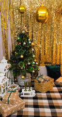 Christmas, New Year interior with golden balloons, garland and New Year decor and gifts under decorated Christmas tree