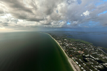 Aerial view of tropical storm over rich neighborhood with expensive vacation homes in Boca Grande,...