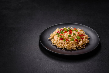 Delicious fresh noodles with sweet pepper, tomato, spices and herbs