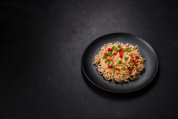Delicious fresh noodles with sweet pepper, tomato, spices and herbs