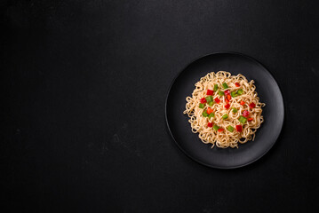 Delicious fresh noodles with sweet pepper, tomato, spices and herbs