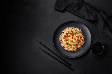 Delicious fresh noodles with sweet pepper, tomato, spices and herbs