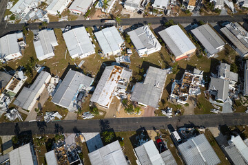 Badly damaged mobile homes after hurricane Ian in Florida residential area. Consequences of natural...
