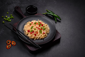 Delicious fresh noodles with sweet pepper, tomato, spices and herbs