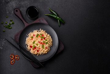 Delicious fresh noodles with sweet pepper, tomato, spices and herbs