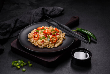 Delicious fresh noodles with sweet pepper, tomato, spices and herbs