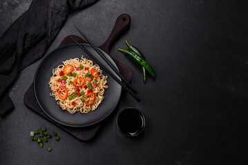 Delicious fresh noodles with sweet pepper, tomato, spices and herbs