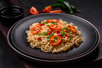 Delicious fresh noodles with sweet pepper, tomato, spices and herbs
