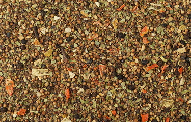 Mixture of spices with dried vegetables and lemon and orange peel, allspice, black pepper, coriander, bay leaf, carrot, parsnip, clove, ginger, leek, onion, parsley, paprika texture, top view