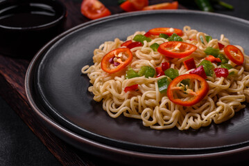 Delicious fresh noodles with sweet pepper, tomato, spices and herbs