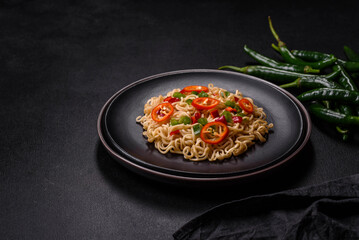 Delicious fresh noodles with sweet pepper, tomato, spices and herbs