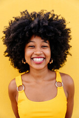 Beautiful young black woman outdoors in the city - Afro american cheerful female adult portrait