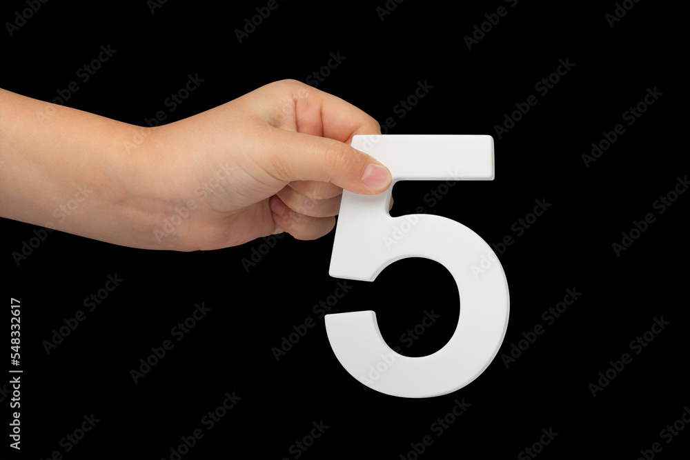 Aufkleber number five in hand isolated on black background. number five in the hand of a child holding on a bl
