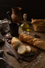 Homemade bread with parchment paper at wood table. Bread on wooden tabletop as baking concept