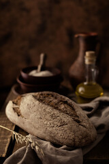 Fresh bread and table cloth on wooden table. Bakery still life and bread at wood tabletop