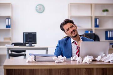 Young male employee in brainstorming concept