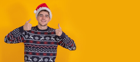 isolated young man with santa claus hat celebrating christmas