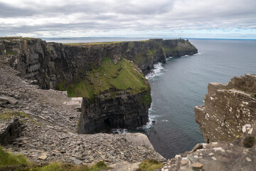 Spectacular view of famous Cliffs of Moher and wild Atlantic Ocean, cloudy day, County Clare, Ireland.