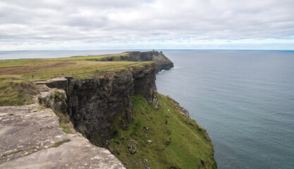 Spectacular view of famous Cliffs of Moher and wild Atlantic Ocean, cloudy day, County Clare, Ireland.