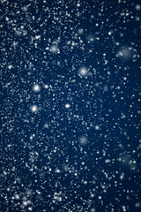 Winter holidays and wintertime background, white snow falling on dark blue backdrop, snowflakes...