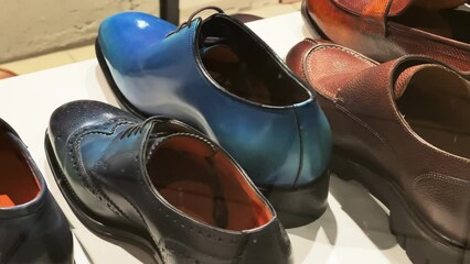Men's classic formal shoes stand in the window of a shoe store