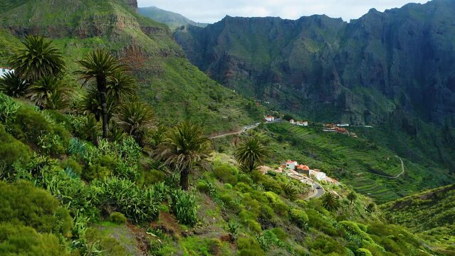 Green mountain landscape with remote settlement village of Masca Gorge, rugged cliffs, ravine. Tenerife Canary Islands Spain.