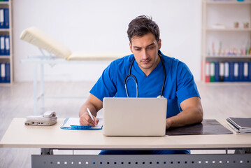 Young male doctor in telemedicine concept
