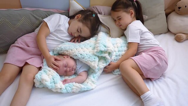 Siblings kids 6 years old girl 3 years old girls and 3 months newborn baby boy. 