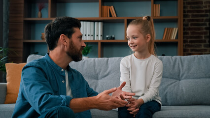 Caucasian man parent father psychologist talk to little cute kid girl teach small child of youth...