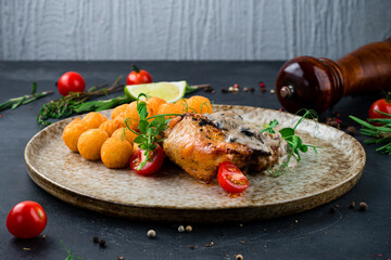 Fried chicken thigh with mushroom sauce and croquettes, fried mashed potato balls with tomatoes and greens.
