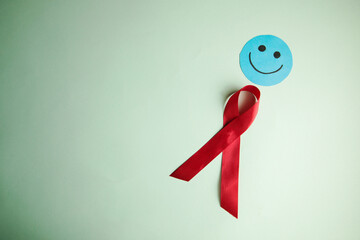 red aids ribbon and smiley face