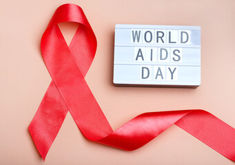 Aids Awareness Sign Red Ribbon. World Aids Day concept. Healthcare and medical concept, World Aids Day. Lightbox with the inscription - World AIDS Day. December 1