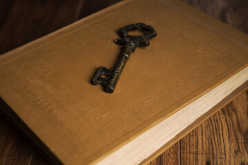 Bronze key on a book