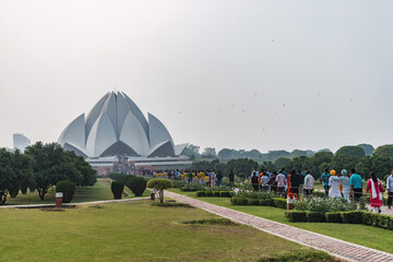 Characteristic architecture of the lotus temple where people go on pilgrimage to pray in New Delhi