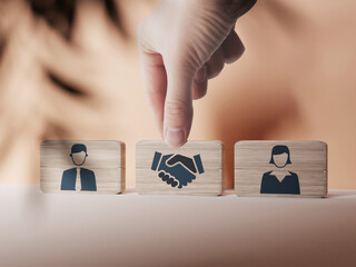 Wooden blocks with an icon of a woman and a man and mediation. Concept of mediation between...