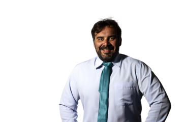 Portrait of a businessman smiling, wearing a shirt and a green tie, looking at the camera.