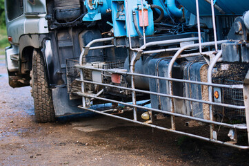 A truck with a large tank for pumping out a septic tank. Close up side view. Equipment control panel with control devices. Selective focus