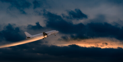 Fototapeta na wymiar A tourist plane takes off in a cloudy evening sky with an abstract line of light behind it. commercial aircraft