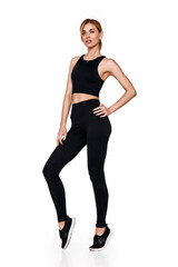 woman in sportswear training . slim girl in black sport leggings