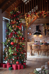 Christmas tree in the chalet. Beautiful New Year's interior in the chalet. Festive mood.