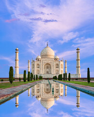 Fototapeta na wymiar Amazing view on the Taj Mahal in sunset light with reflection in water. The Taj Mahal is an ivory-white marble mausoleum on the south bank of the Yamuna river. Agra, Uttar Pradesh, India.