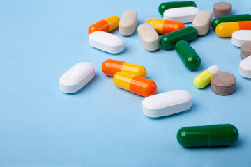 Top view of different pills on blue background,copy space for text,backdrop with copy space.