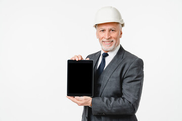 Caucasian middle-aged mature engineer architect construction worker in hardhat using tablet with mockup screen application for real estate isolated in white background