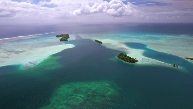 Aerial shot flying towards man-made channel and island in tropical Palmyra Atoll, Pacific Ocean