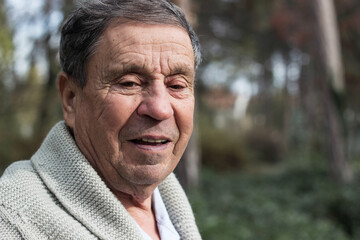 Portrait of a smiling senior man in an autumn park