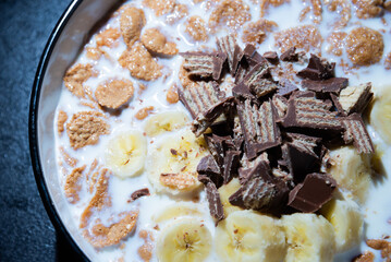 Cereal dessert with milk and banana with chocolate
