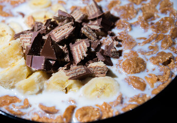 Cereal dessert with milk and banana with chocolate