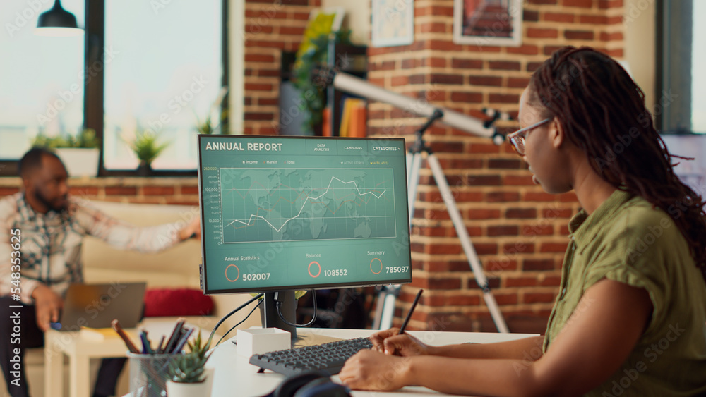 Poster african american woman working remote on data sales report, using financial diagrams on computer. fr