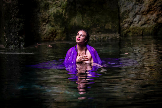 A Lovely Nude Latin Model Enjoys The Beautiful Waters In The Cenotes Near Cuzama, Yucatan, Mexico