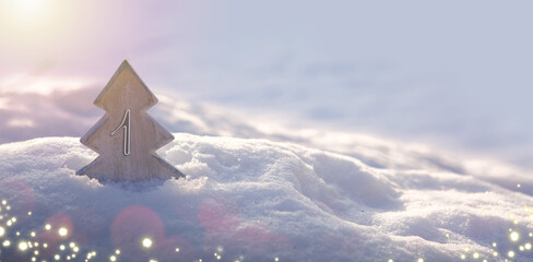First Advent. Christmas background with fir tree and lights on snow.